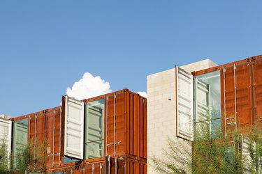 Brown shipping container buildings with trees