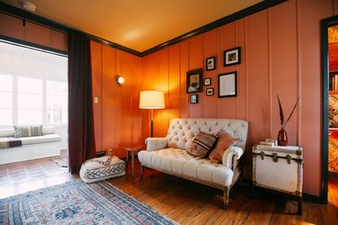 room with brown floors and terra cotta walls