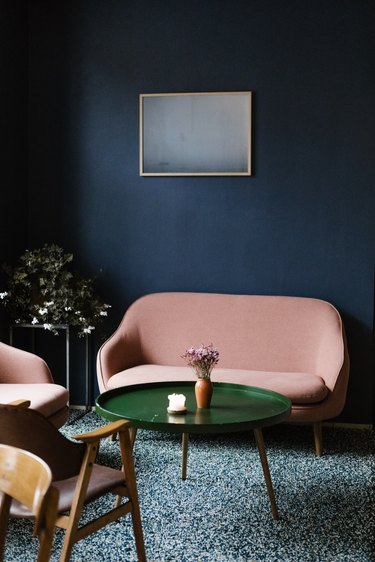 colors that go with blue, retro pink sofa and green coffee table on green shag rug and blue wall