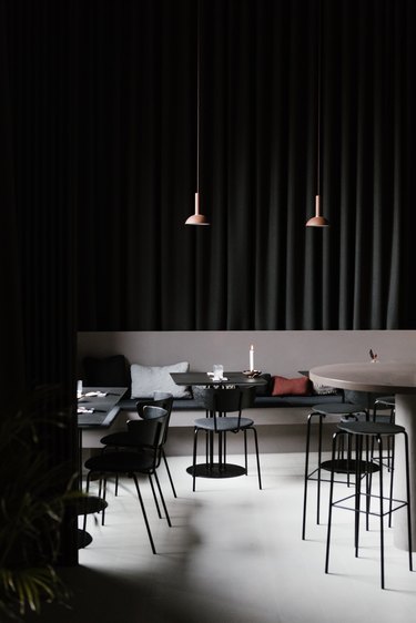 Minimalist bar with black dining furniture and pendant lights