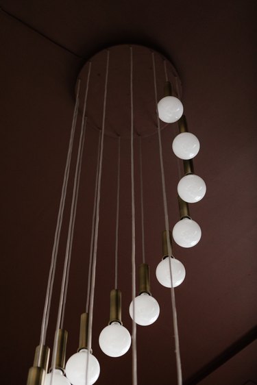 Sphere pendant lights hanging from brown wall
