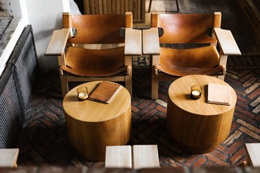 Wood accent chairs and coffee tables on brick floor