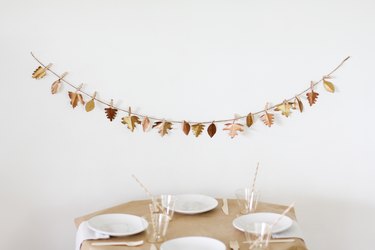 Leaf garland with kids dining table with paper table cloth and disposable dishware