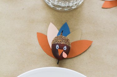 Thanksgiving decoration with multi colored papers and painted acorn