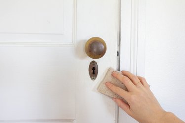 Hand sanding white door