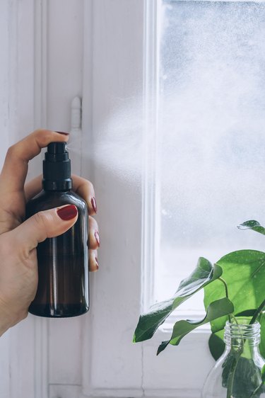 spraying the air with diy room spray