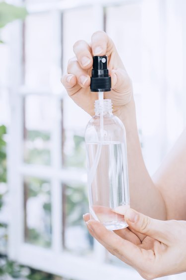 a small spray bottle full of water and rubbing alcohol