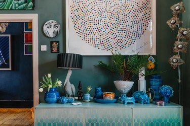 hunter green wall paint with blue accents and turquoise cabinet