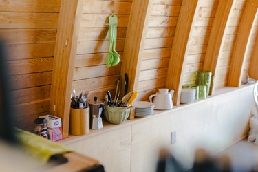 dishware on an open shelf in the kitchen area