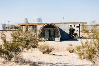 a view of the nearly cylindrical entryway to a desert home
