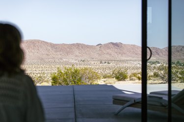 a view through a window of desert and mountains