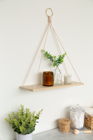 Wall plant shelving made from wood board and macrame yarn with plants
