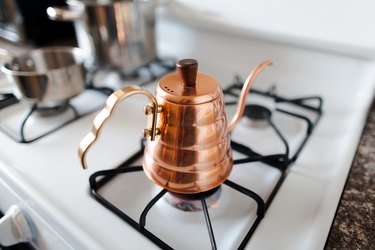 copper tea pot on gas stove