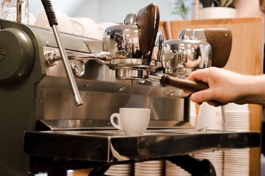 a barista pulls a shot at an espresso machine