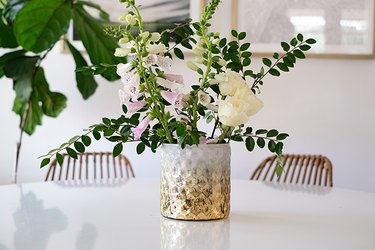 Textured gold-white vase with pink and white flowers and leaves