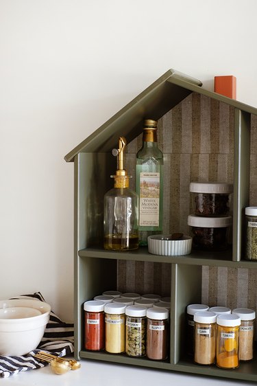 Scandinavian wood spice house with striped wallpaper and spice containers
