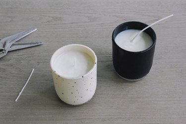 Candle wax with wicks, cooling in black and white candle holders