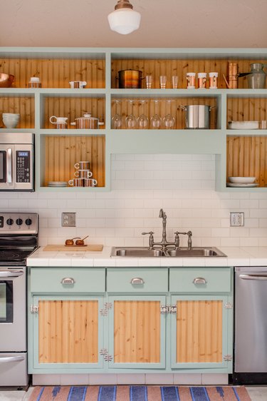 light blue kitchen with wood panels