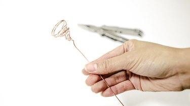 a piece of copper wire that has been twisted into a spiral at one end, and the spiral stretched into a cup shape