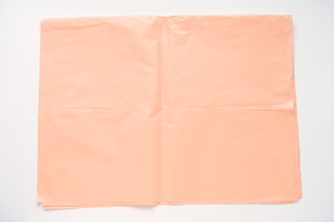 Pink tissue paper against a white background