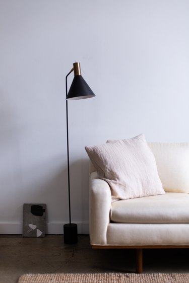 white couch and black floor lamp