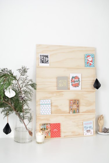 holiday cards sit on shelves made from thin strips of moulding glued to a plywood sheet