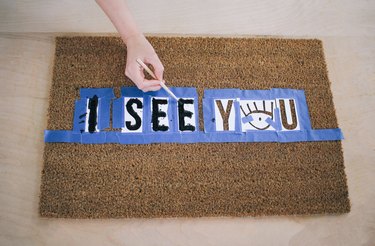 Painting doormat with stenciled letters