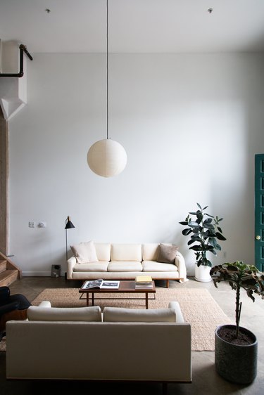 mid-century modern white living room with round pendant light