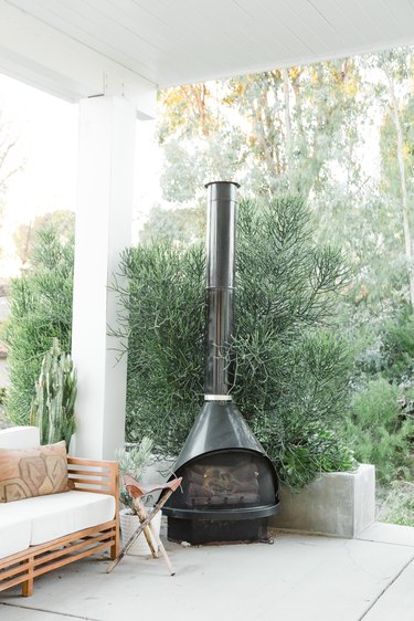 Outdoor patio with black freestanding fireplace