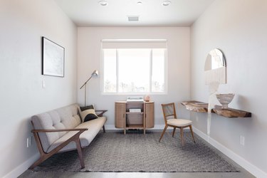 Minimalist living room with a gray and neutral theme, wood furniture, and organic decor.