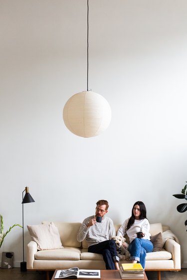 man and woman sitting on couch in mid-century modern living room