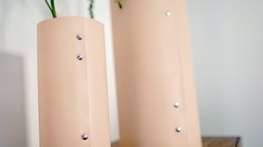 Beige leather vases with silver rivets
