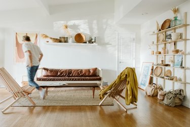 Man walking through boho living room