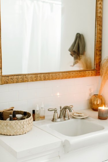 small boho bathroom with large mirror above sink