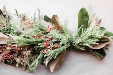 Winter-themed centerpiece with live foliage and berries