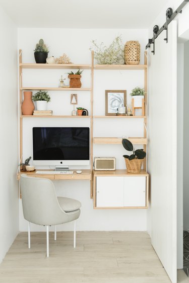 Scandinavian home office with open shelving and barn sliding door