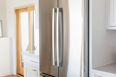 Double doors of a stainless steel fridge.