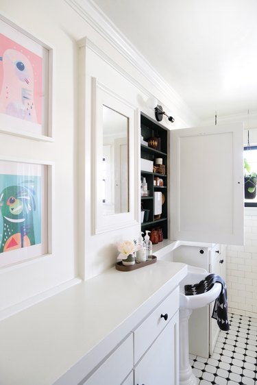 White walled bathroom with black and white tile floor