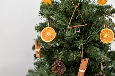 Tree with ornaments made from dried orange slices, pinecones, twigs and cinnamon sticks