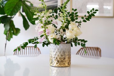 Textured white and gold vase with gold and pink flowers