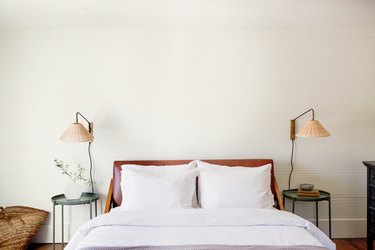 white bedding, round bedside tables and lamps