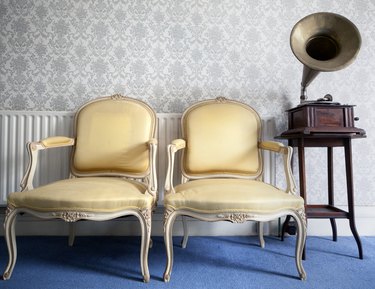 two yellow silk chairs and a gramophone