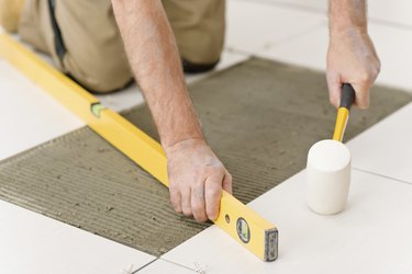 Home improvement, renovation - handyman laying tile