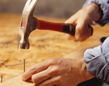Man hammering nail, (Close-up)