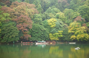 "Boats on Katsura river at fall in Arashiyama, Japan"