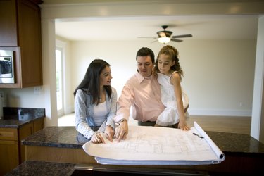 Family looking at blueprints in new home