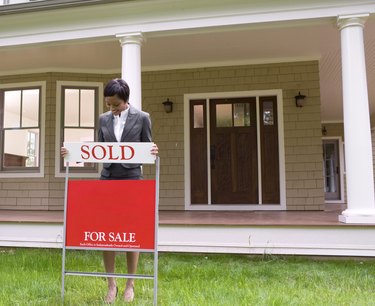 Realtor with sale sign
