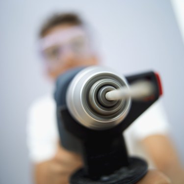 young man holding a drill machine