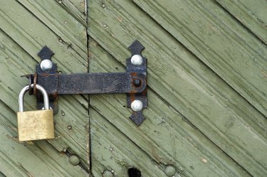 Close-up of a wooden door with a padlock