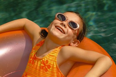 Girl floating in pool